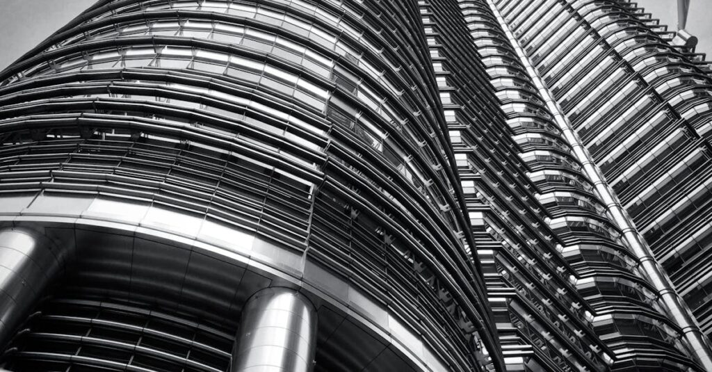 Low angle shot of the iconic Petronas Twin Towers in Kuala Lumpur showcasing modern architecture.